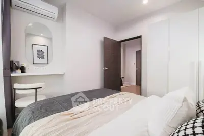 Modern bedroom with stylish decor and air conditioning in a contemporary apartment.