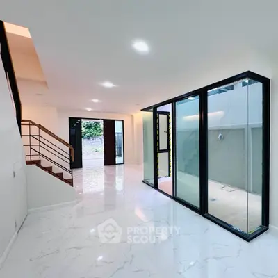 Modern interior with sleek staircase and large glass windows