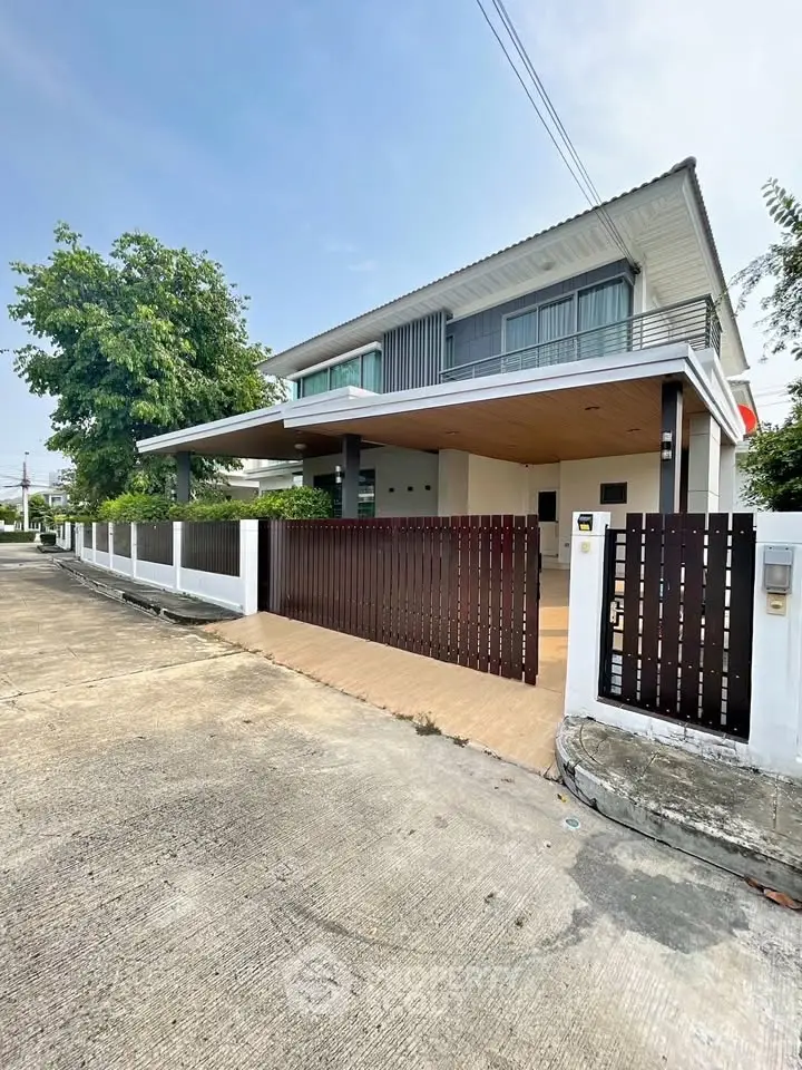 Modern two-story house with sleek design and spacious driveway in a serene neighborhood.