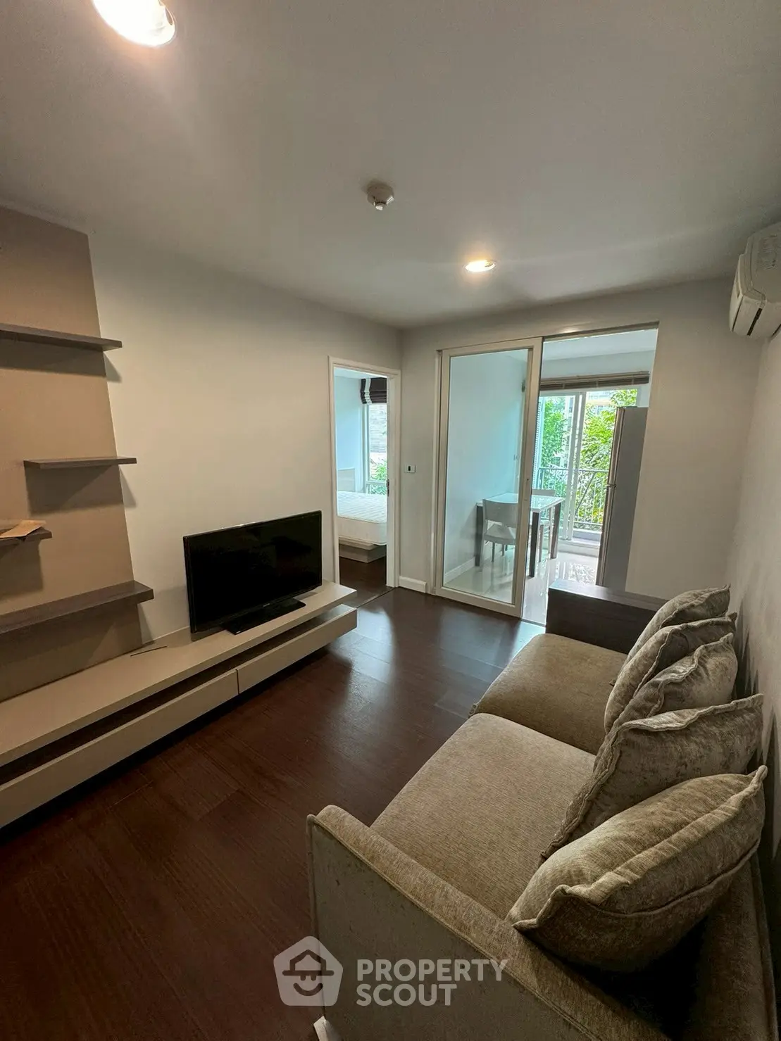 Modern living room with sleek furniture and natural light, perfect for relaxation and entertainment.