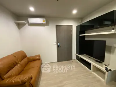 Modern living room with leather sofa and wall-mounted TV unit