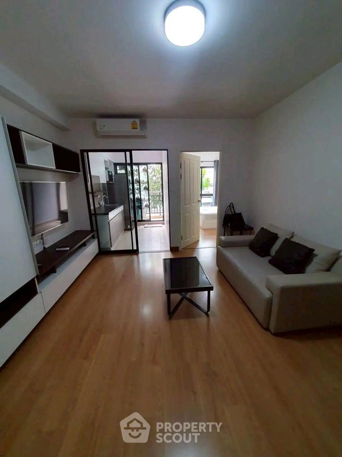 Modern living room with sleek furniture and open kitchen layout