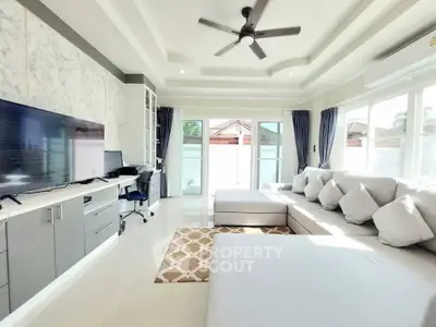 Spacious modern living room with large windows and stylish furniture