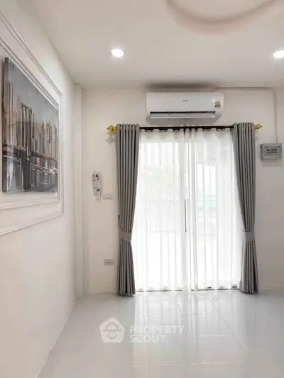 Bright and airy living room with modern air conditioning and elegant curtains.