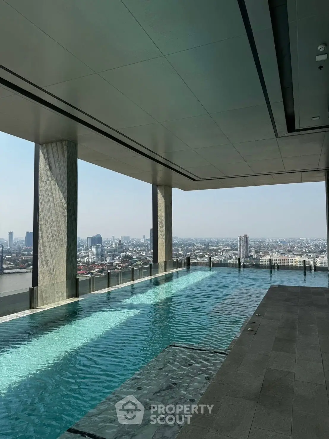 Luxurious rooftop pool with stunning city skyline view, perfect for relaxation and leisure.