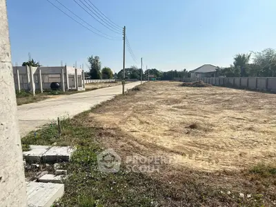 Spacious vacant land plot with clear sky, ideal for development opportunities.