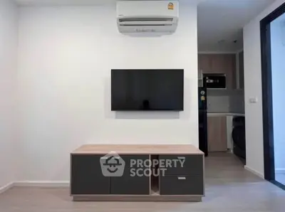 Modern living room with wall-mounted TV and sleek air conditioning unit.