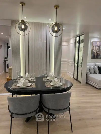 Modern dining area with elegant lighting and stylish decor in a contemporary apartment.