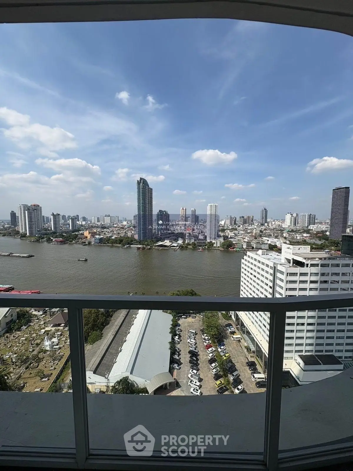 Stunning cityscape view from high-rise balcony overlooking river and skyline.
