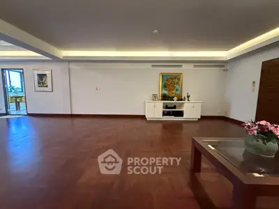Spacious living room with elegant wooden flooring and modern decor