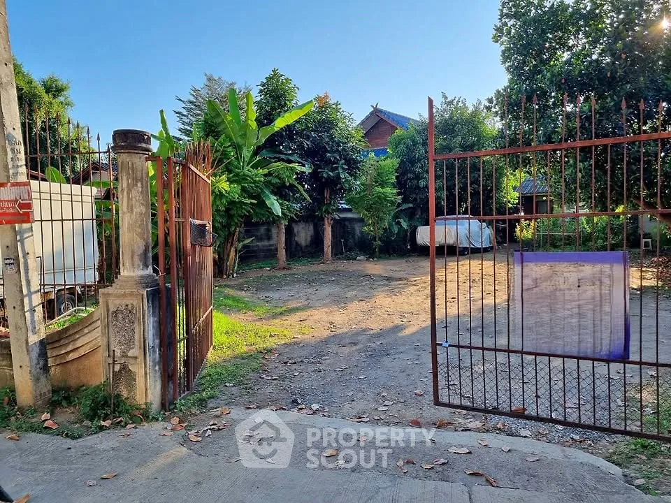 Spacious gated property with lush greenery and ample open space, perfect for development opportunities.
