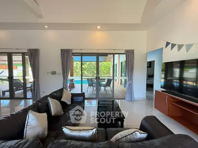 Spacious living room with pool view and modern decor