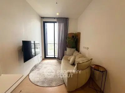 Cozy living room with modern decor and balcony view, perfect for relaxation.