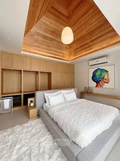Luxurious bedroom with modern design, wooden ceiling, and cozy ambiance.