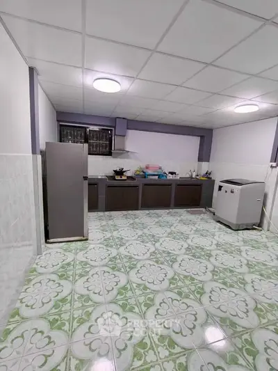 Spacious kitchen with modern appliances and stylish tile flooring