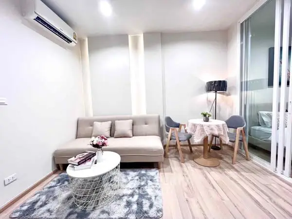 Modern living room with cozy sofa and dining area in stylish apartment