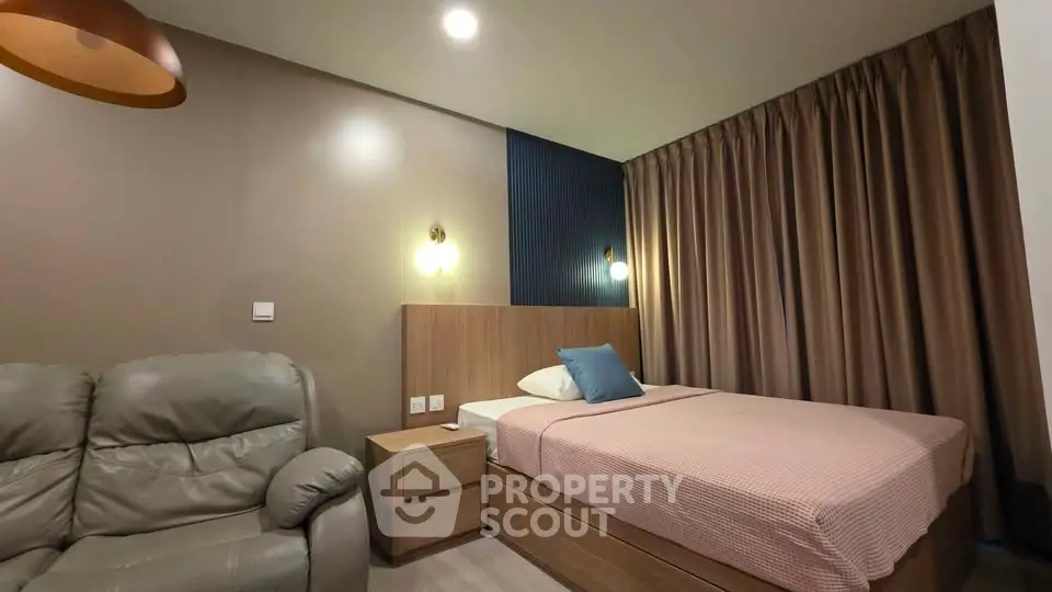 Cozy bedroom with modern decor and comfortable seating area