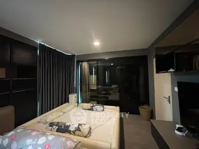 Modern bedroom with stylish decor and large windows for natural light.