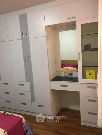 Spacious bedroom with modern built-in wardrobe and cozy decor