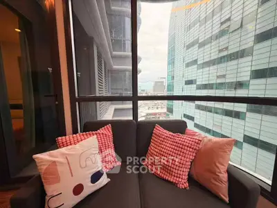 Modern apartment balcony with cozy seating and stunning city view