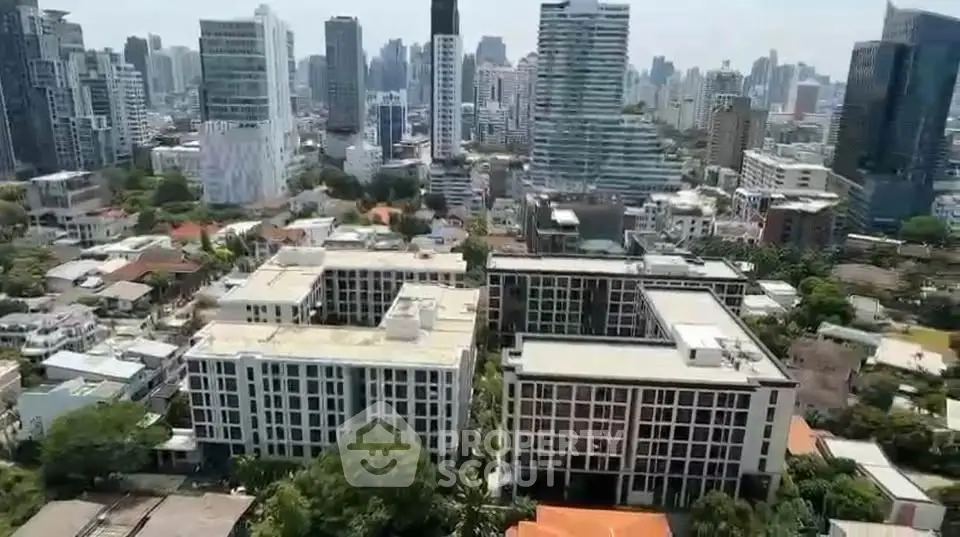 Stunning aerial view of modern cityscape with high-rise buildings and lush greenery.
