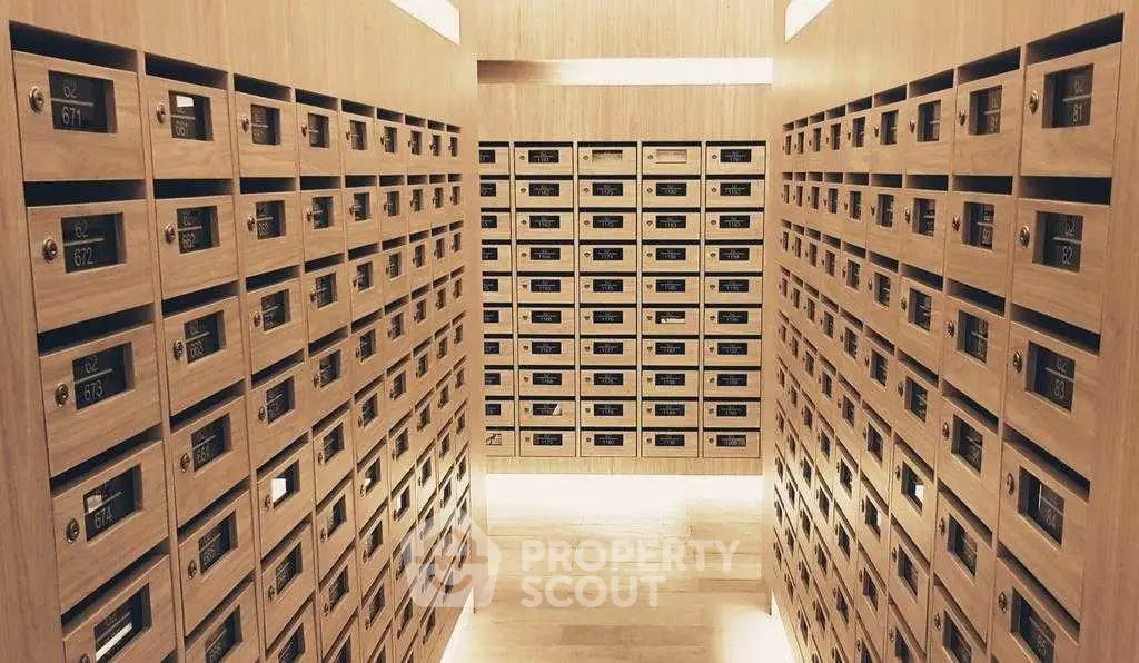 Modern apartment building mailroom with sleek wooden mailboxes and ambient lighting.
