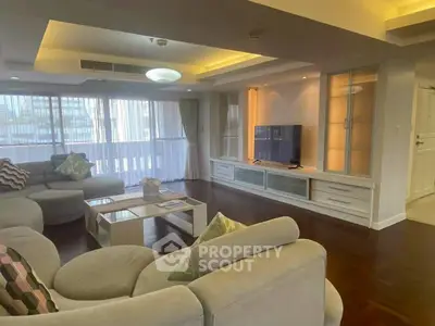 Spacious living room with modern furniture and large windows for natural light.