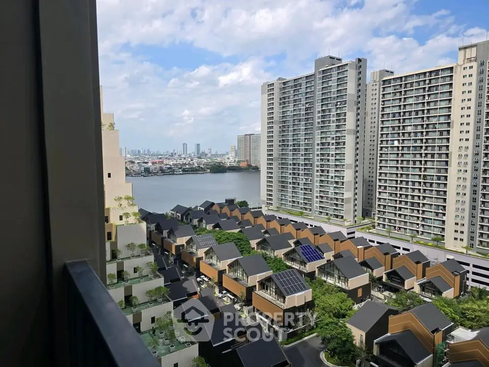 Stunning high-rise view of modern cityscape with river and residential buildings.