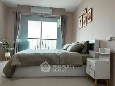 Modern bedroom with stylish decor and city view from balcony.