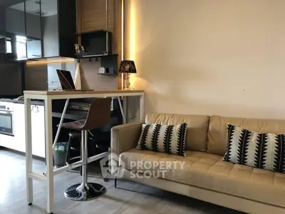 Modern living room with stylish kitchen and cozy seating area