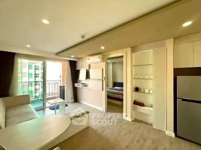 Modern living room with open layout and balcony access in a stylish apartment.