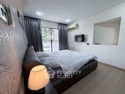 Modern bedroom with stylish decor and balcony access