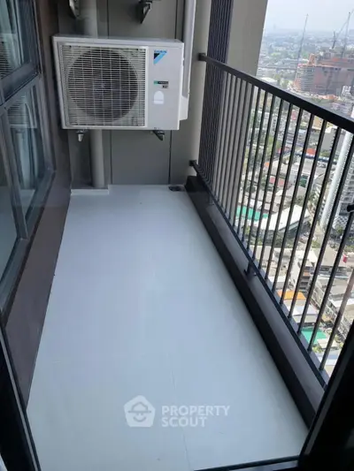 Compact balcony with city view and air conditioning unit