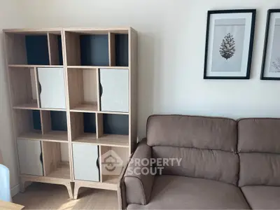 Modern living room with stylish bookshelf and comfortable sofa, perfect for cozy relaxation.