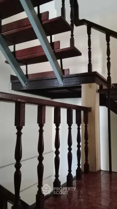 Elegant wooden staircase with classic railing in a modern home interior