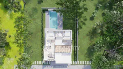 Aerial view of modern house with pool and lush garden