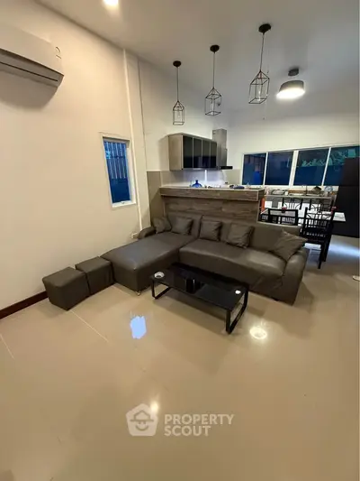 Modern living room with open kitchen and stylish lighting