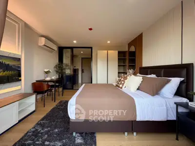 Spacious modern bedroom with stylish decor and ample natural light, perfect for relaxation and comfort.