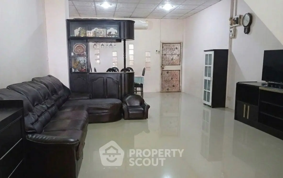 Spacious living room with leather sofa and modern entertainment center