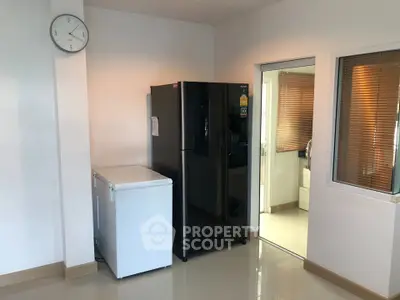 Modern kitchen with black fridge and white freezer in a sleek interior design.