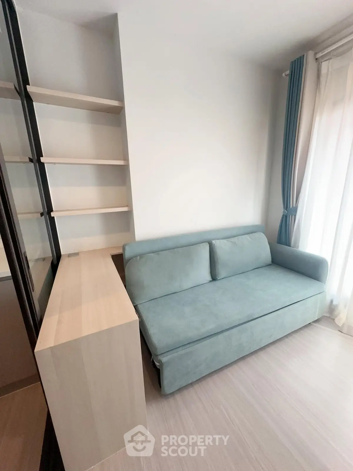 Modern living room with sleek sofa and built-in shelving, perfect for urban living.
