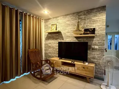 Charming living room with rustic brick wall, wooden furniture, and cozy ambiance.