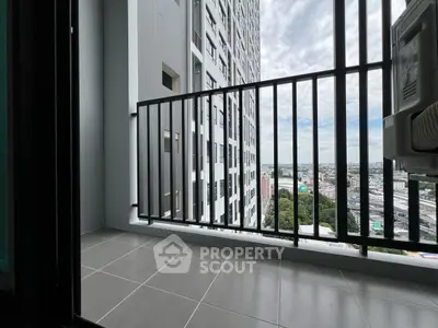 Modern high-rise balcony with city view and sleek railing design.