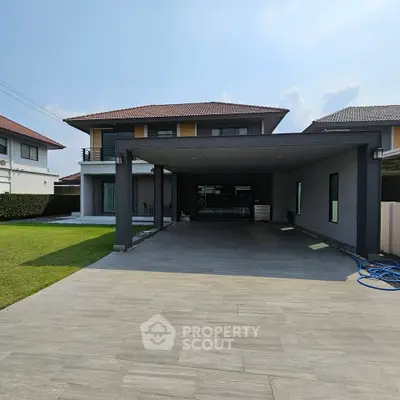Spacious modern house with large driveway and manicured lawn in a serene neighborhood.