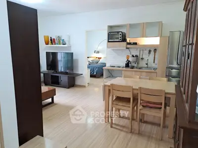 Spacious open-plan living and dining area with modern kitchen appliances