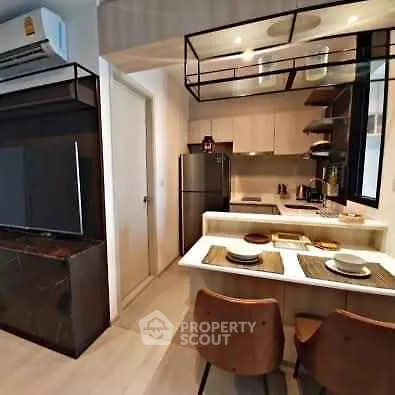 Modern kitchen with open layout and stylish dining area in a contemporary apartment.