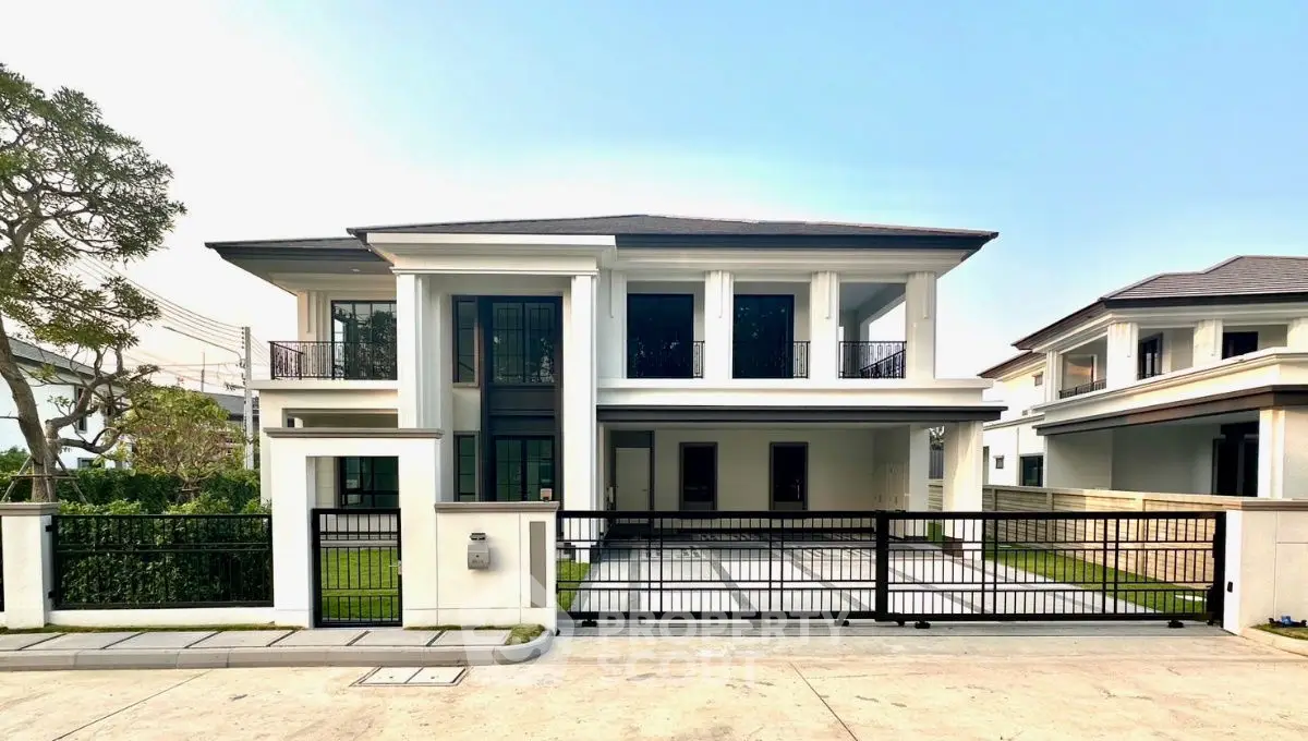 Elegant modern two-story house with spacious driveway and manicured lawn in a serene neighborhood.
