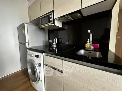 Modern kitchen with sleek appliances and wooden cabinetry