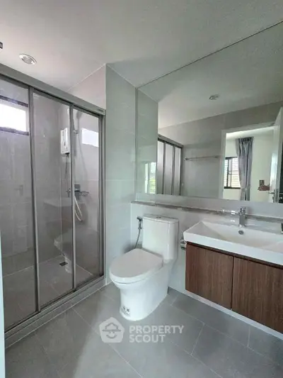 Modern bathroom with glass shower and sleek fixtures