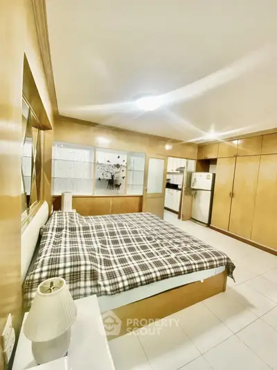 Spacious bedroom with built-in wardrobes and cozy lighting, perfect for relaxation and comfort.